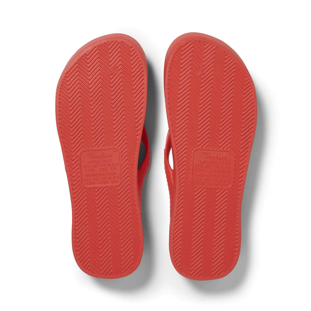 Archies Arch Support Thongs in coral pictured upside down from the bottom